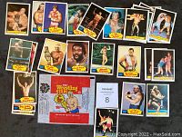 Lot of 30 vintage 1985 WWF wrestling trading cards spread on black surface with wax wrapper included.