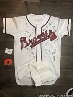 Front view of the white XL button-up 1992 Atlanta Braves jersey showing multiple signatures and the team logo including tomahawk design.