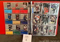 Full binder page showing front and back sides of hockey cards, arranged in nine-pocket plastic pages.
