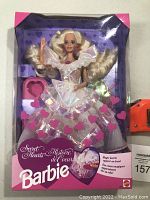 Front view of unopened Barbie Secret Hearts doll in original box wearing iridescent layered dress and heart-themed accessories.