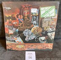 Front cover of Frank Zappa 1973 LP Overnite Sensation in original shrink wrap with price sticker, showing detailed surreal and eclectic artwork.