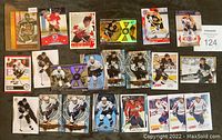Assorted hockey cards spread out, includes Canada team cards and Pittsburgh Penguins cards
