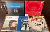 Lot of 5 vintage vinyl LP albums from the 1960's featuring rock and pop artists, arranged side by side. Distinctive red velvet cover on Bee Gees 'Odessa' double album is visible. Covers show moderate wear, consistent with age.