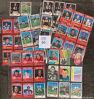 Full view of 53 CFL football cards showing a variety of players dating primarily from 1970 and 1971, also 1961 and 1965, with player portraits and action shots in various card designs.