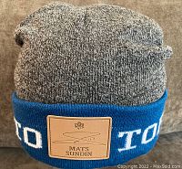 Full view of the grey and blue Mats Sundin Toronto Maple Leafs tuque with leather patch on front.