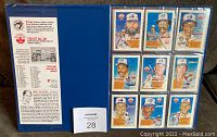 View of 9 baseball cards in the binder's protective page, showing player portraits and information