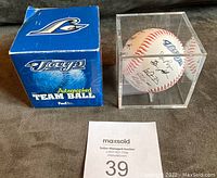 Blue Jays autographed team ball box with baseball displayed inside clear Plexiglass holder.