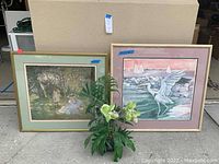 Photo showing both framed artworks and the artificial plant together.