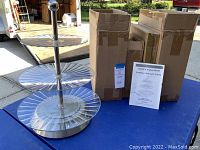 Two Cook's Essentials rotating 3-tier party platters displayed with their boxes.