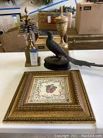 Group photo of the fruit picture, metal cast quail, and gold decorative stands including the pinecone.