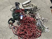 Overview of mixed indoor and outdoor extension cords in red, green, black, and white colors