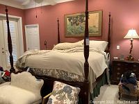 Full view of king size four poster bed with mattress and box spring in master bedroom setting.