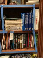 Shelf of pilot instructional books and others including medical and statistics books. Covers focus on aviation and instrument flight.