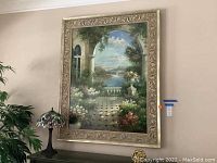 Full view of large wall art hanging on wall with visible painted architectural garden landscape and ornate frame.