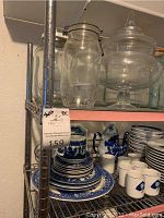 Side view of metal shelving unit showing some items stored which are not included. Shelf size and construction visible.