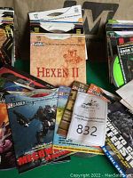 Photo showing a stack of demo discs including Hexen II and MechWarrior: Virgin in paper sleeves with PC Gamer branding.