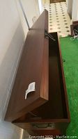 Lift-top open revealing internal storage compartment of the sofa table