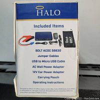 Back of the box showing included items: jumper cables, USB to Micro USB cable, AC wall power adapter, 12V car power adapter, carrying pouch, operating instructions.