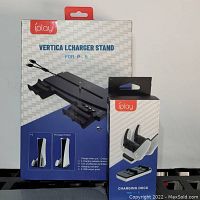 Front view of iPlay Vertical Charger Stand for PS5 and Charging Dock in their retail packaging.