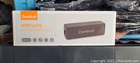 Box front showing image and branding of wireless stereo speaker by Zamkol.