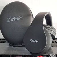 Black Zihnio foldable wireless headset alongside matching black semi-hard carrying case with Zihnio logo.