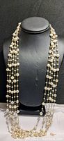 Full view of the 5-strand cultivated pearl necklace displayed on black bust.