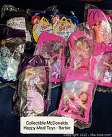 Lot of sealed vintage McDonald's Barbie Happy Meal toys in original packaging, showing multiple different dolls.