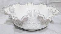 White Fenton Spanish Lace bowl with clear ruffled edge, side view