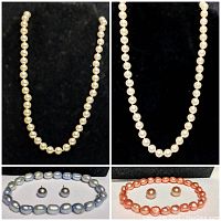 Second white pearl necklace with round pearls on black background