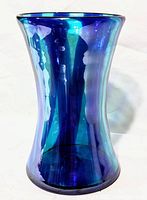 Angled side view showing the vase's blue opalesque finish and flared top shape.