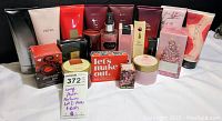 Full lot of Avon lotions and perfumes numerous items in pink, red, burgundy and gold packaging