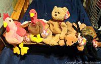 Photo showing 5 vintage Beanie Babies including Curly, Gobbles, Doodle, Sly, and Spinner, all with Ty tags and P.V.C. pellet fill.