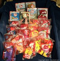 Overview of multiple small McDonald's Beanie Babies plush bears in original plastic bags, plus three boxed International Bears II series bears.