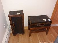 Cabinet and side table placed on a hardwood floor, showing suitcase style textured surfaces and leather-like handles