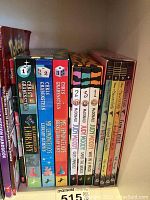 Photo of spines of multiple children's books and book series including Chris Grabenstein and Judy Moody series, as well as an Encyclopedia of Ancient Egypt.