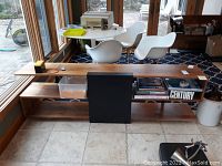 Front view of full shelf showing wood finish, central metal panel and overall length