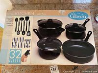 Box packaging of Gibson 32-piece Kitchen Combos set showing cookware, flatware, and utensils images