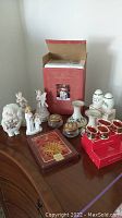 Overall view of lot showing holiday figurines, Lenox candlesticks, Spode shakers, napkin rings, decorative boxes.