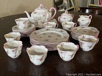Overview of entire tea service on table showing all pieces.