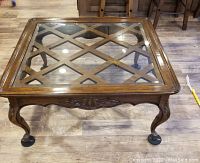 Top view showing bevelled glass with lattice wood design insert and carved apron beneath.