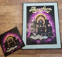 Framed colorful Ghostface poster featuring Ghostface as a king with portraits of former presidents, seated on a throne with money and briefcases. Poster glass broken.