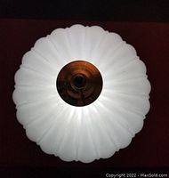 Top view of the frosted glass shade showing the melon shape and brass fixture center detail.