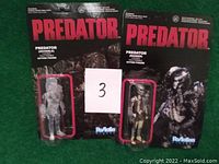Two 2013 Predator ReAction Series 3 3/4" action figures in original carded packaging: one masked figure and one invisible figure.