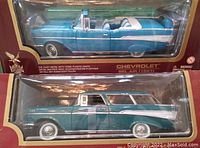 Two boxed Road Legends diecast models, a 1957 Chevrolet Bel Air convertible in blue on top and a 1957 Chevrolet Nomad station wagon in green below, both unopened in their packaging.