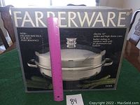 Front view of Farberware electric 12-inch skillet and high dome cover box along with a pink ruler for scale and a lot number card.