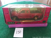 Front view of the boxed 1:18 scale red Ford Pick-Up F-150 model showing MIRA branding and packaging with clear plastic window.