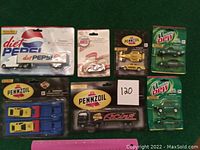All 8 die cast vehicles in original packaging showing brands Diet Pepsi, Pennzoil and Mountain Dew by Golden Wheel Die Cast Co.