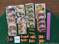 Full lot overview showing various small vintage Zylmex toy construction vehicles and tractors, some packaged and some loose.