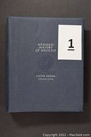 Blue presentation folio closed, embossed with “Medallic History of Medicine,” “Limited Edition,” and “Sterling Silver.”