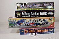 Four Sunoco collectible trucks stacked in original boxes with clear edition and feature labels.